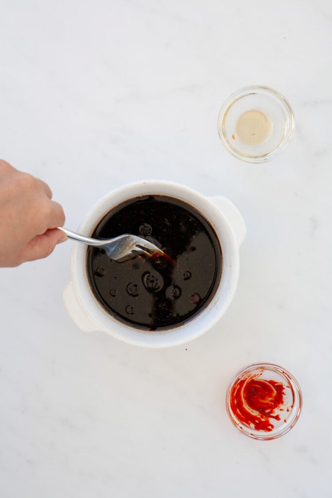 brown sugar and soy sauce mixture being stirred in a small bowl
