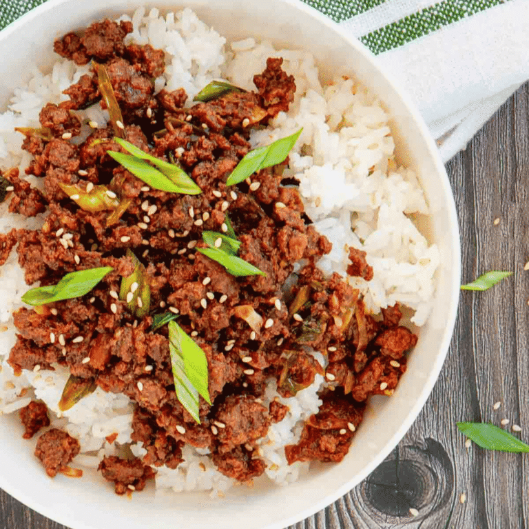 Craving a fast dinner that's packed with flavor? These Korean Ground Beef Bowls are the ultimate weeknight meal, made with tender ground beef coated in a sweet, savory, and slightly spicy Korean-inspired sauce with soy sauce, brown sugar, garlic, ginger, sesame oil, and gochujang. Served over fluffy rice and topped with green onions and sesame seeds, this easy Ground Beef Bowl is ready in just 15 minutes. Perfect for Easy Ground Beef Recipes, Korean Beef Rice Bowls, Ground Beef Dinner Ideas, Quick Family Meals, Asian Inspired Recipes, Weeknight Dinner Recipes, Meal Prep Bowls, Rice Bowl Recipes, Ground Beef and Rice, and Budget Friendly Dinners, this simple recipe is one you'll make again and again.