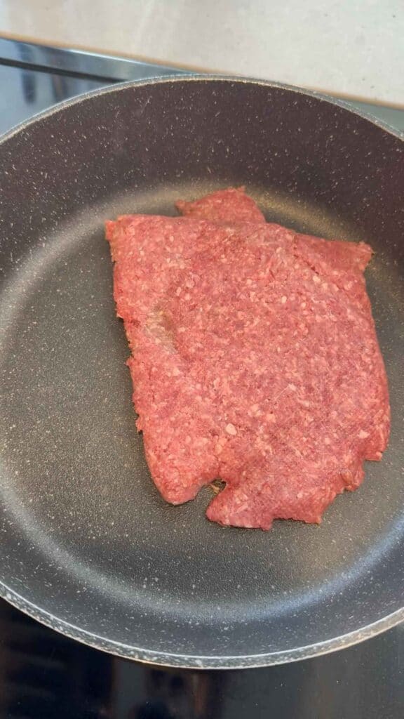 raw ground beef in a skillet