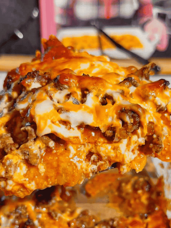 Looking for an easy enchilada casserole the whole family will love? These Lazy Enchiladas are packed with seasoned ground beef, crunchy tortilla chips, rich red enchilada sauce, and loads of melted cheddar cheese for the ultimate comfort food dinner. This simple Mexican-inspired casserole skips the rolling but keeps all the bold flavor, making it perfect for busy weeknights, family dinners, potlucks, and meal prep. If you love easy ground beef recipes, cheesy casserole recipes, Tex-Mex dinners, quick family meals, tortilla chip casseroles, budget-friendly dinners, and simple comfort food recipes, this Lazy Enchiladas recipe is guaranteed to become a regular on your dinner menu. Save this easy enchilada casserole recipe for your next stress-free dinner!