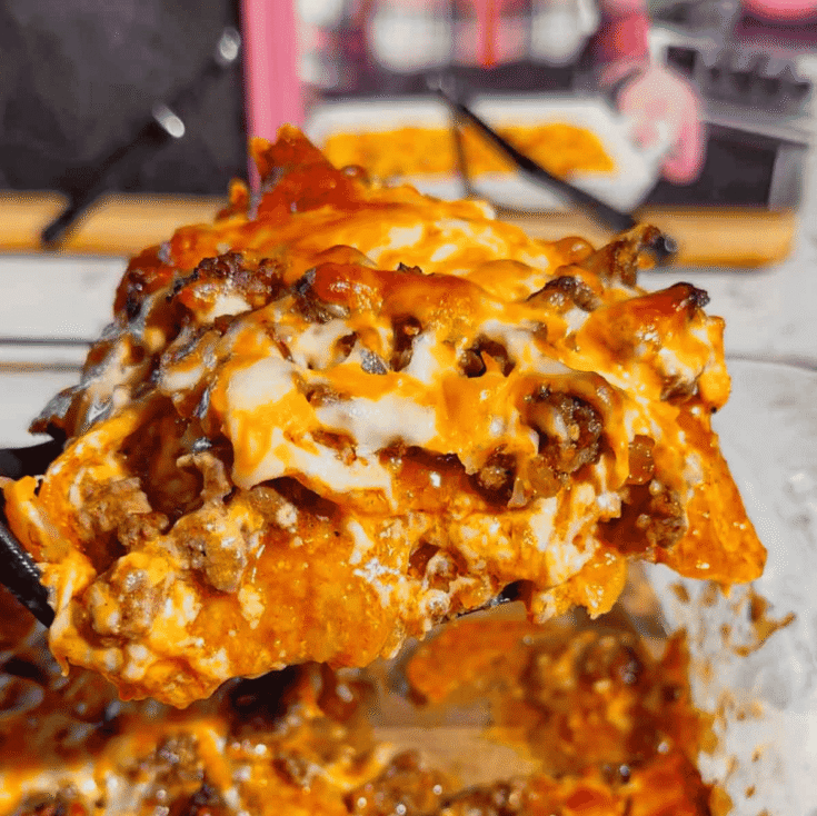 Looking for an easy enchilada casserole the whole family will love? These Lazy Enchiladas are packed with seasoned ground beef, crunchy tortilla chips, rich red enchilada sauce, and loads of melted cheddar cheese for the ultimate comfort food dinner. This simple Mexican-inspired casserole skips the rolling but keeps all the bold flavor, making it perfect for busy weeknights, family dinners, potlucks, and meal prep. If you love easy ground beef recipes, cheesy casserole recipes, Tex-Mex dinners, quick family meals, tortilla chip casseroles, budget-friendly dinners, and simple comfort food recipes, this Lazy Enchiladas recipe is guaranteed to become a regular on your dinner menu. Save this easy enchilada casserole recipe for your next stress-free dinner!