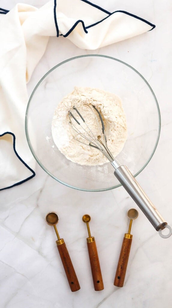 whisking together dry ingredients in a mixing bowl