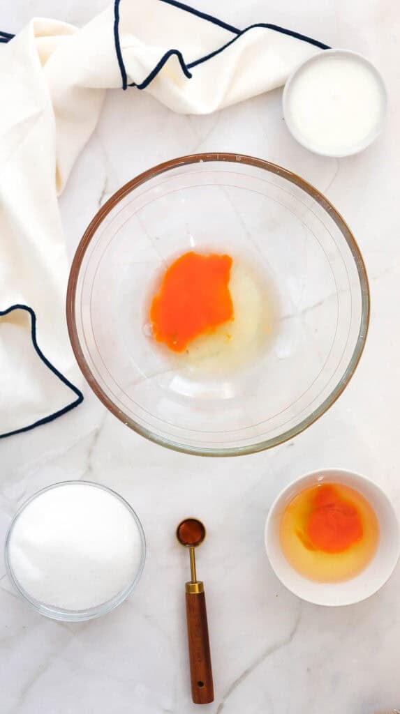eggs and sugar in a glass mixing bowl