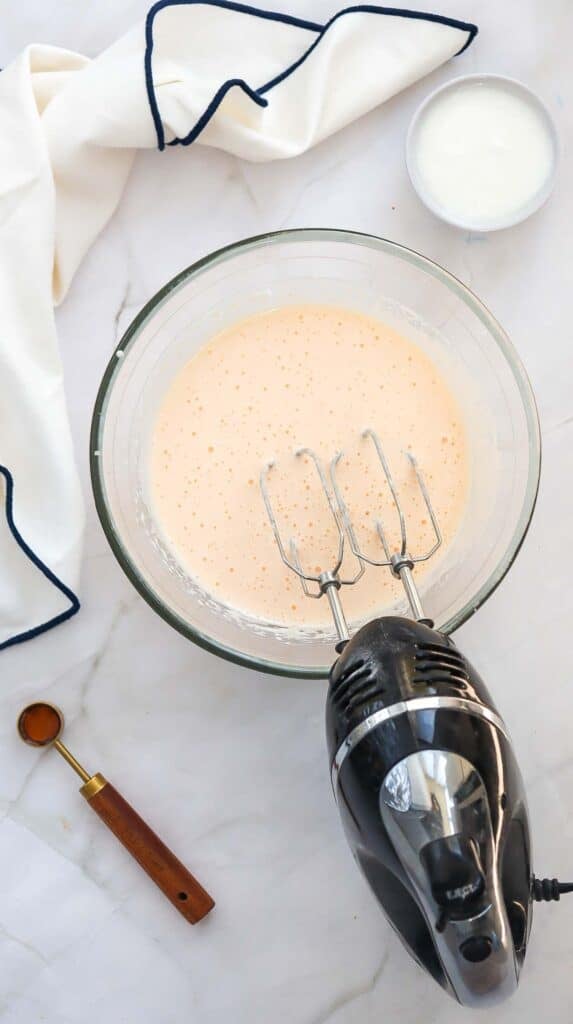 eggs and sugar being beat with an electric mxer