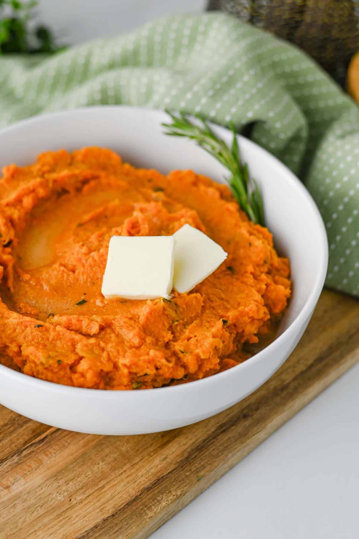 These Mashed Sweet Potatoes are the ultimate creamy, buttery side dish for holidays and family dinners. If you're looking for the best mashed sweet potatoes recipe, this easy homemade version is packed with fresh sage, rosemary, maple syrup, cinnamon, and nutmeg for incredible flavor in every bite. These creamy sweet potatoes are smooth, rich, and perfect for Thanksgiving, Christmas, Easter, or Sunday dinner. Whether you need an easy holiday side dish, sweet potato recipes, Thanksgiving side dishes, mashed potatoes alternative, or comforting fall recipes, this simple recipe is always a crowd-pleaser. Save this delicious homemade mashed sweet potatoes recipe for your next festive meal or cozy family dinner!