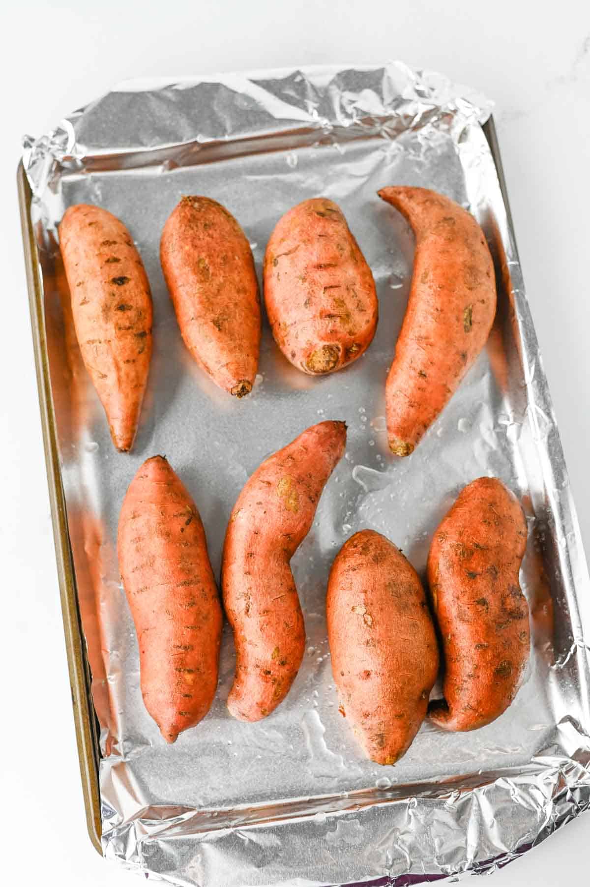 sweet potatoes on a foil lined baking sheet