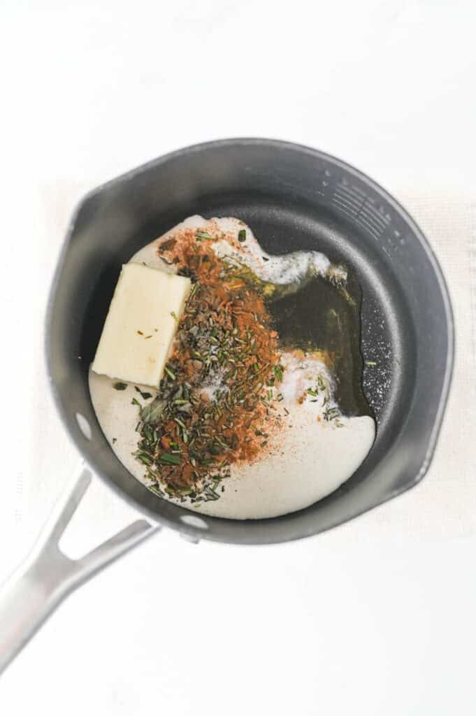 butter, cream, sage, rosemary, cinnamon, nutmeg, and salt in a sauce pan