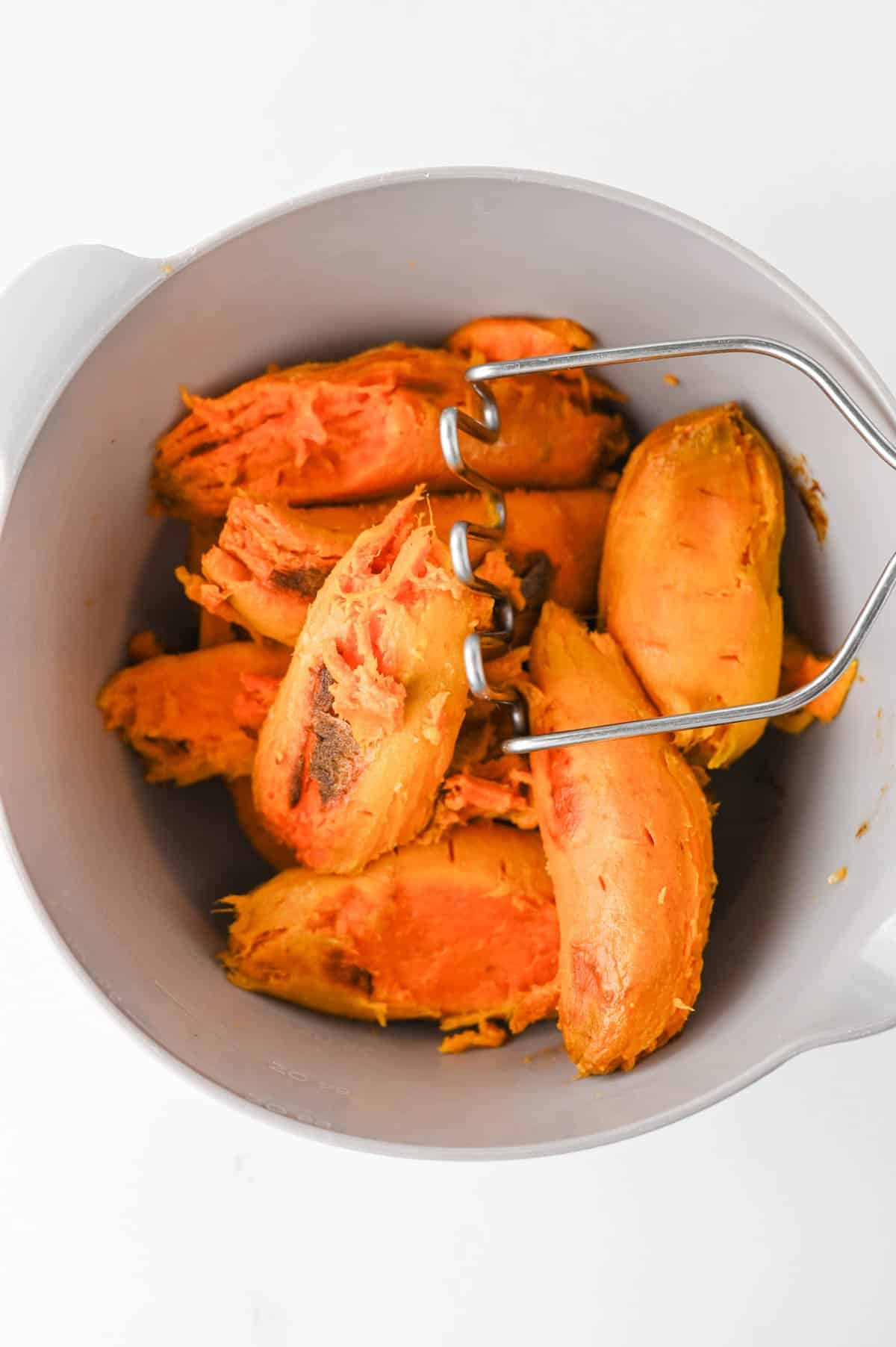 cooked and peeled sweet potatoes in a large mixing bowl