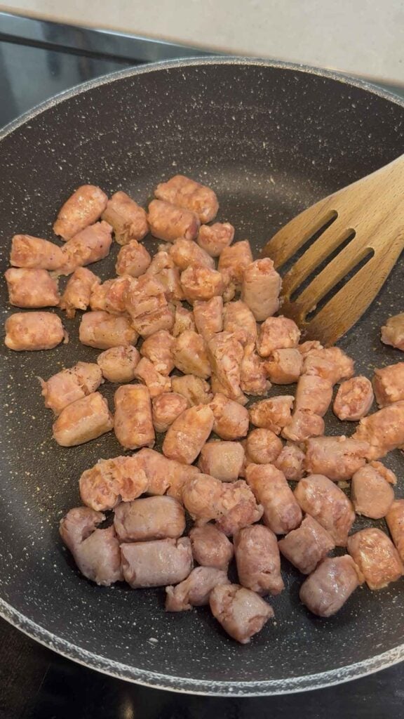 raw sausage meat in a skillet