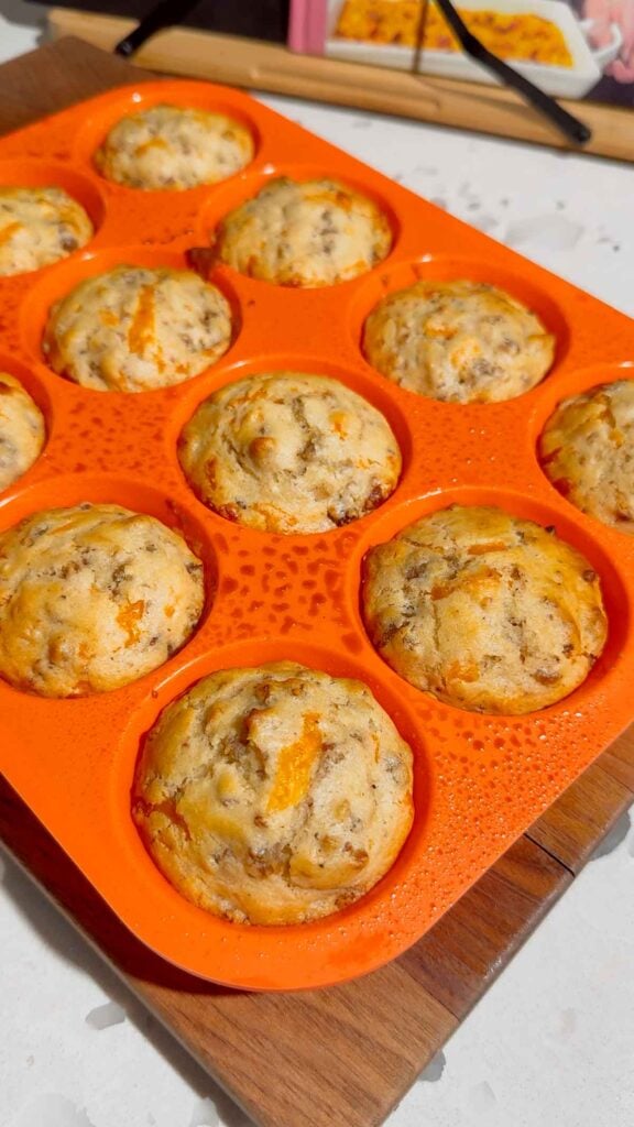 Looking for the ultimate make ahead breakfast? These McGriddle Muffins combine fluffy pancake batter, maple sausage, crispy bacon, melted cheddar cheese, and sweet maple syrup into the perfect grab-and-go breakfast recipe. They're freezer friendly, meal prep approved, kid friendly, and ready in just 30 minutes, making them ideal for busy weekday mornings, weekend brunch, school breakfasts, and holiday mornings. If you love easy breakfast recipes, breakfast muffins, pancake muffins, savory breakfast ideas, maple sausage recipes, brunch recipes, breakfast meal prep, freezer breakfast recipes, and family breakfast ideas, these homemade McGriddle Muffins are a delicious shortcut everyone will request again and again.