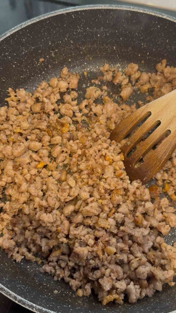 crumbled sausage and bacon mixture in a skillet