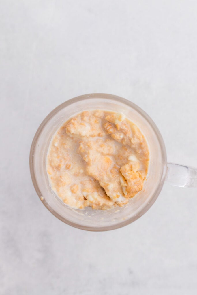 milk and crushed golden oreos mixed together in a glass mug