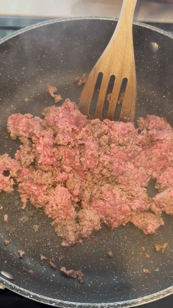crumbling ground beef in a skillet