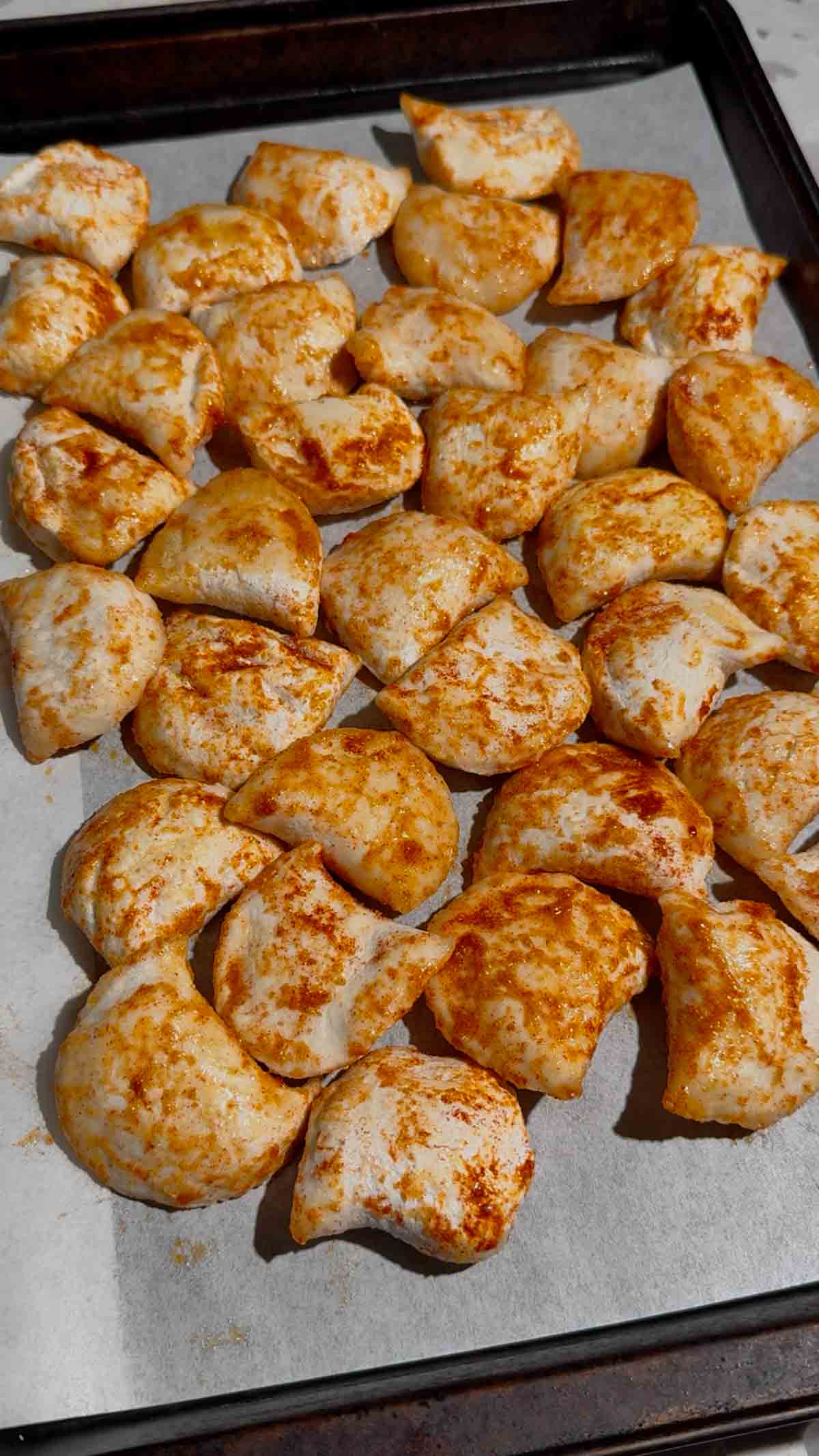 seasoned pierogies on a parchment lined baking sheet