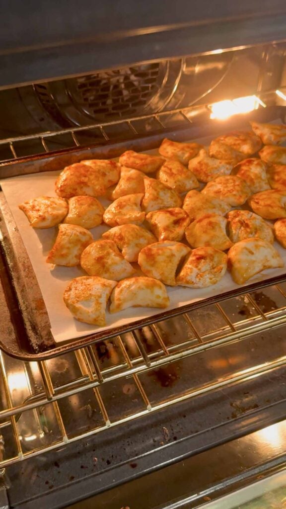 seasoned pierogies baking in an oven