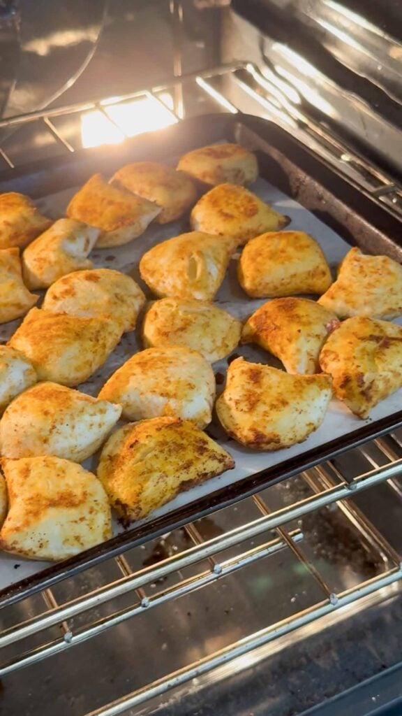 seasoned pierogies on a baking sheet in the oven