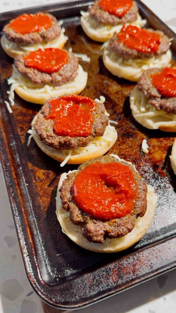 pizza sauce on top of hamburger patties