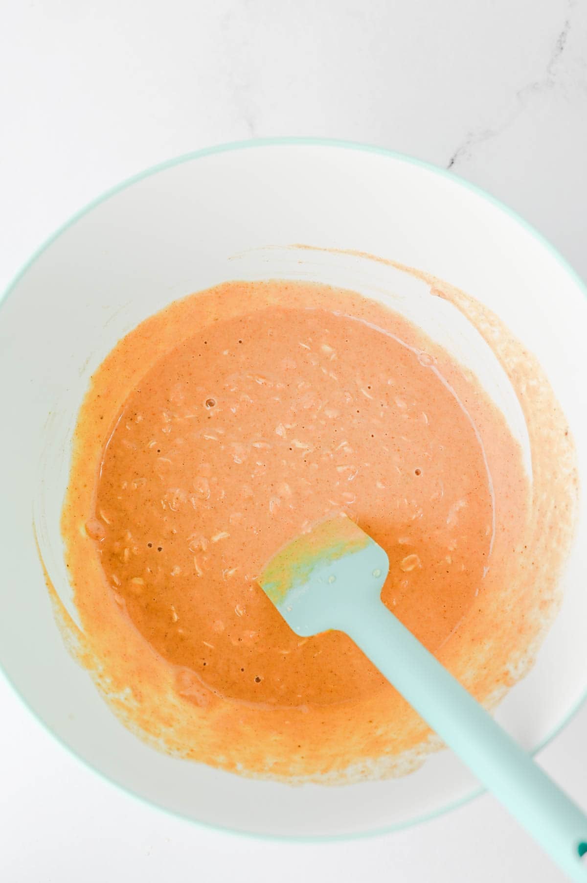 pumpkin overnight oats ingredients stirred together in a mixing bowl