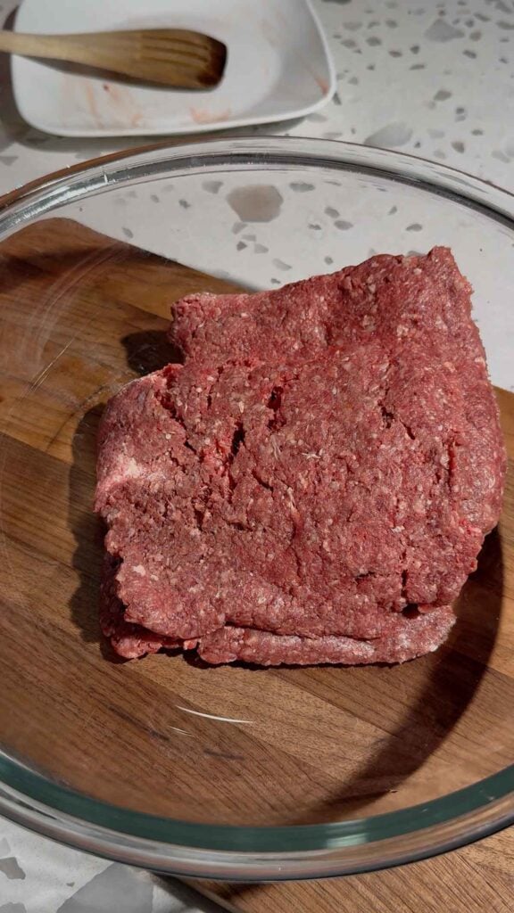 raw ground beef in a glass bowl