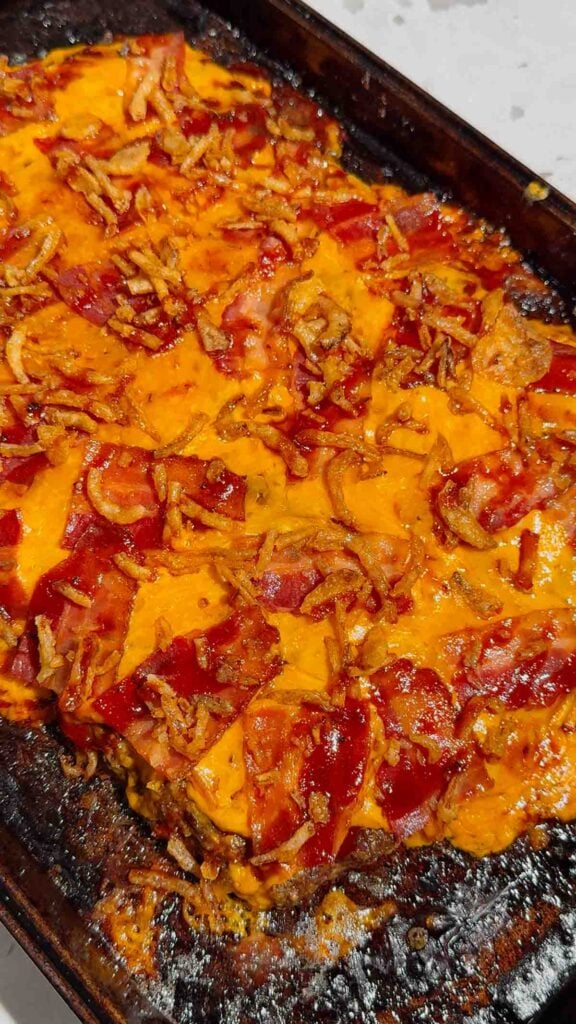 Looking for the ultimate Sheet Pan BBQ Bacon Cheeseburger Meatloaf recipe? This easy family dinner combines juicy ground beef, smoky BBQ sauce, crispy bacon, melty cheddar cheese, and crunchy fried onions for a comfort food meal everyone will love. If you're searching for Sheet Pan Dinners, Easy Meatloaf Recipes, Ground Beef Dinner Ideas, Weeknight Dinner Ideas, Family Dinner Recipes, Cheeseburger Meatloaf, BBQ Meatloaf Recipe, Easy Ground Beef Recipes, Comfort Food Dinners, Sheet Pan Meals, or Quick Dinner Recipes, this crowd-pleasing recipe belongs on your menu. Ready in just 45 minutes with simple ingredients, it's perfect for busy nights, meal planning, potlucks, or whenever you're craving a cheesy, bacon-loaded dinner the whole family will request again and again.