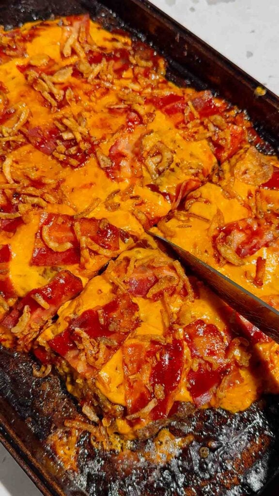 Looking for the ultimate Sheet Pan BBQ Bacon Cheeseburger Meatloaf recipe? This easy family dinner combines juicy ground beef, smoky BBQ sauce, crispy bacon, melty cheddar cheese, and crunchy fried onions for a comfort food meal everyone will love. If you're searching for Sheet Pan Dinners, Easy Meatloaf Recipes, Ground Beef Dinner Ideas, Weeknight Dinner Ideas, Family Dinner Recipes, Cheeseburger Meatloaf, BBQ Meatloaf Recipe, Easy Ground Beef Recipes, Comfort Food Dinners, Sheet Pan Meals, or Quick Dinner Recipes, this crowd-pleasing recipe belongs on your menu. Ready in just 45 minutes with simple ingredients, it's perfect for busy nights, meal planning, potlucks, or whenever you're craving a cheesy, bacon-loaded dinner the whole family will request again and again.