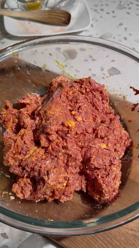 raw meatloaf mixture in a glass bowl