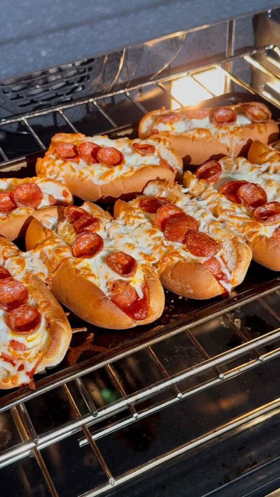 pizza dogs baking in the oven until cheese starts to brown