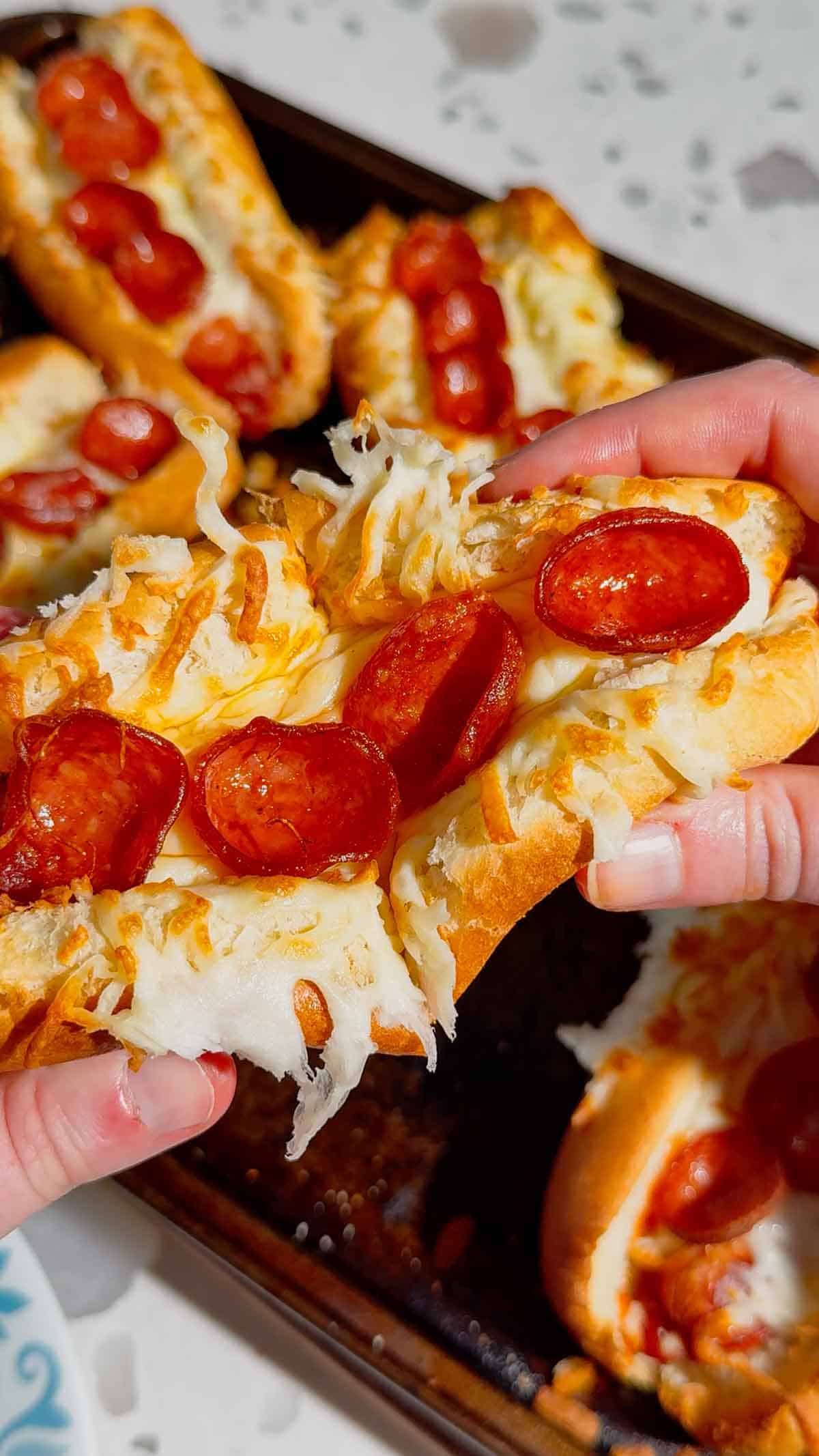 These Sheet Pan Pizza Dogs are the ultimate easy family dinner for busy nights! If you're looking for Weeknight Dinner Ideas, Easy Dinner Recipes For Family, or Quick Dinner Ideas everyone will actually eat, this fun mashup of pizza and hot dogs is a guaranteed winner. Crispy hot dog buns are loaded with pizza sauce, pepperoni, melty mozzarella cheese, and juicy hot dogs for a cheesy meal that's ready in under 20 minutes. Perfect for Lazy Dinners, Kid Friendly Meals, Game Day Food, Easy Supper Recipes, Family Dinner Ideas, Quick And Easy Dinner Recipes, Budget Friendly Meals, Easy Sheet Pan Recipes, Pizza Recipes, Hot Dog Recipes, and Simple Weeknight Meals. Save this easy pizza dog recipe for your next fast dinner, party, or fun family meal!