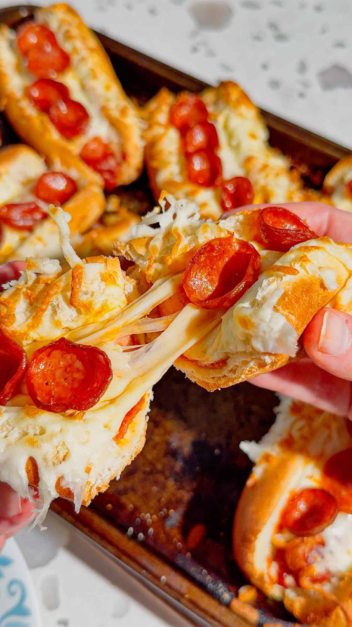 These Sheet Pan Pizza Dogs are the ultimate easy family dinner for busy nights! If you're looking for Weeknight Dinner Ideas, Easy Dinner Recipes For Family, or Quick Dinner Ideas everyone will actually eat, this fun mashup of pizza and hot dogs is a guaranteed winner. Crispy hot dog buns are loaded with pizza sauce, pepperoni, melty mozzarella cheese, and juicy hot dogs for a cheesy meal that's ready in under 20 minutes. Perfect for Lazy Dinners, Kid Friendly Meals, Game Day Food, Easy Supper Recipes, Family Dinner Ideas, Quick And Easy Dinner Recipes, Budget Friendly Meals, Easy Sheet Pan Recipes, Pizza Recipes, Hot Dog Recipes, and Simple Weeknight Meals. Save this easy pizza dog recipe for your next fast dinner, party, or fun family meal!