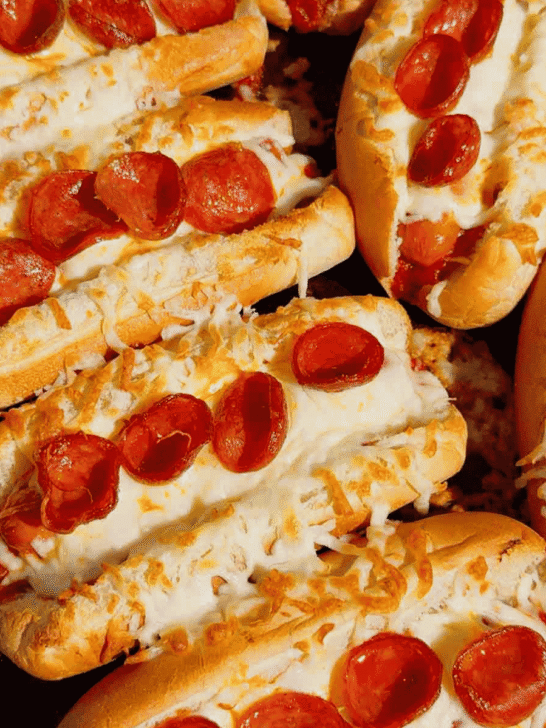 These Sheet Pan Pizza Dogs are the ultimate easy family dinner for busy nights! If you're looking for Weeknight Dinner Ideas, Easy Dinner Recipes For Family, or Quick Dinner Ideas everyone will actually eat, this fun mashup of pizza and hot dogs is a guaranteed winner. Crispy hot dog buns are loaded with pizza sauce, pepperoni, melty mozzarella cheese, and juicy hot dogs for a cheesy meal that's ready in under 20 minutes. Perfect for Lazy Dinners, Kid Friendly Meals, Game Day Food, Easy Supper Recipes, Family Dinner Ideas, Quick And Easy Dinner Recipes, Budget Friendly Meals, Easy Sheet Pan Recipes, Pizza Recipes, Hot Dog Recipes, and Simple Weeknight Meals. Save this easy pizza dog recipe for your next fast dinner, party, or fun family meal!