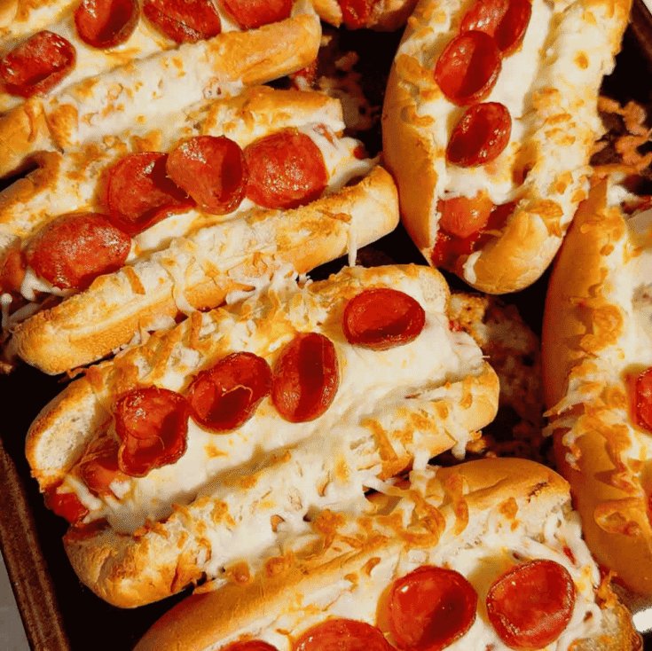 These Sheet Pan Pizza Dogs are the ultimate easy family dinner for busy nights! If you're looking for Weeknight Dinner Ideas, Easy Dinner Recipes For Family, or Quick Dinner Ideas everyone will actually eat, this fun mashup of pizza and hot dogs is a guaranteed winner. Crispy hot dog buns are loaded with pizza sauce, pepperoni, melty mozzarella cheese, and juicy hot dogs for a cheesy meal that's ready in under 20 minutes. Perfect for Lazy Dinners, Kid Friendly Meals, Game Day Food, Easy Supper Recipes, Family Dinner Ideas, Quick And Easy Dinner Recipes, Budget Friendly Meals, Easy Sheet Pan Recipes, Pizza Recipes, Hot Dog Recipes, and Simple Weeknight Meals. Save this easy pizza dog recipe for your next fast dinner, party, or fun family meal!