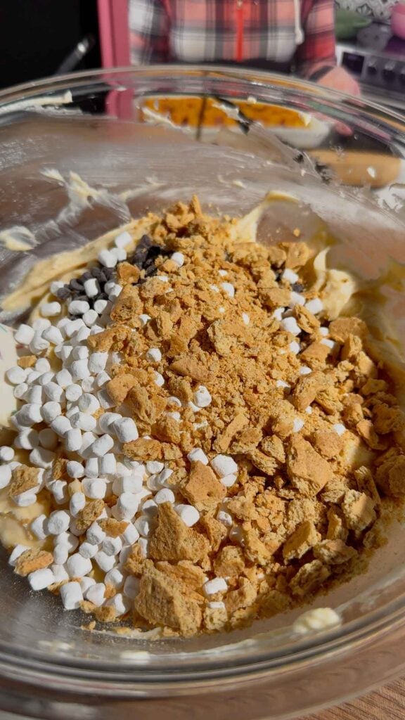 crumbled graham crackers, dehydrated marshmallows and mini chocolate chips added to bowl with cream cheese mixture