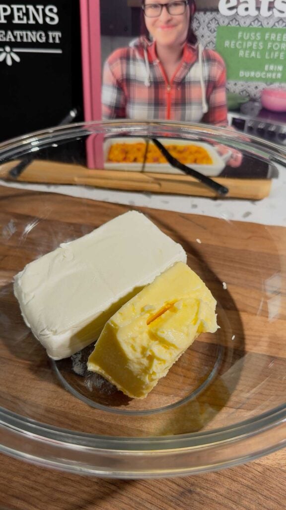 butter and cream cheese in a glass mixing bowl