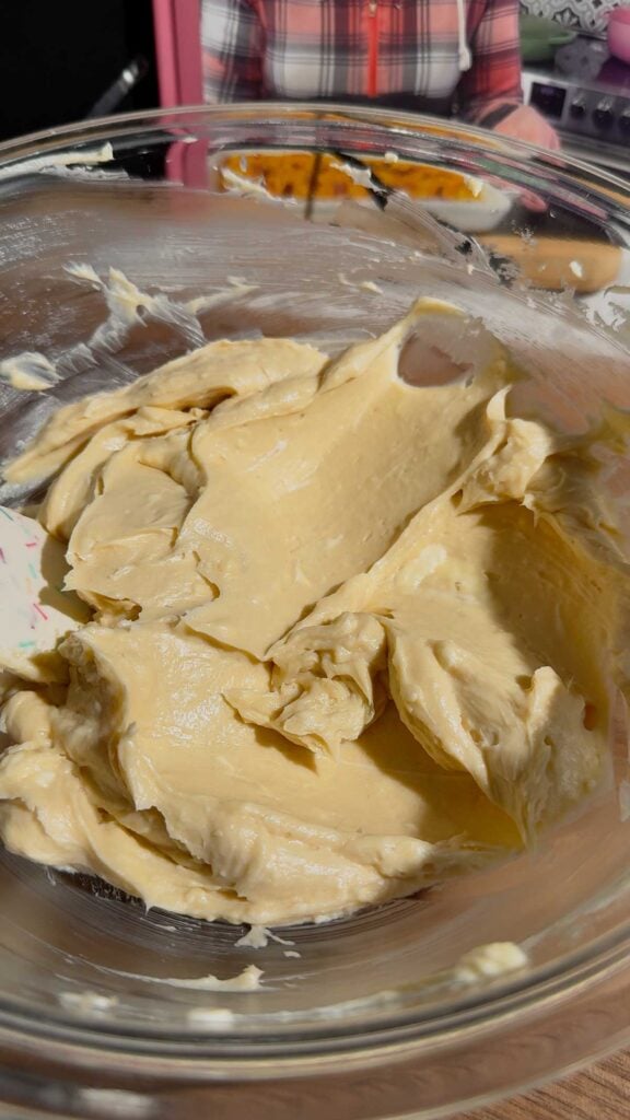 creamed butter, cream cheese and sugar mixture in a glass mixing bowl