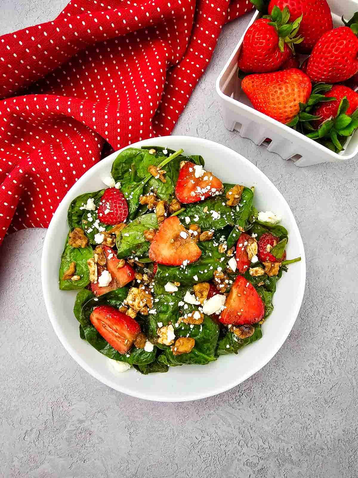 Looking for a fresh and easy salad recipe everyone will love? This Strawberry Spinach Salad is loaded with baby spinach, juicy fresh strawberries, crunchy walnuts, and creamy feta cheese, all tossed in a simple homemade balsamic dressing. It's the perfect healthy salad for spring and summer, whether you need a quick lunch, light dinner, side dish, picnic recipe, or potluck favorite. This easy spinach salad comes together in just 10 minutes with simple ingredients and is packed with sweet and savory flavor in every bite. Save this strawberry salad recipe for busy weeknights, holiday meals, BBQs, bridal showers, Mother's Day brunch, or anytime you're craving a fresh, colorful, and delicious salad that's both beautiful and satisfying.