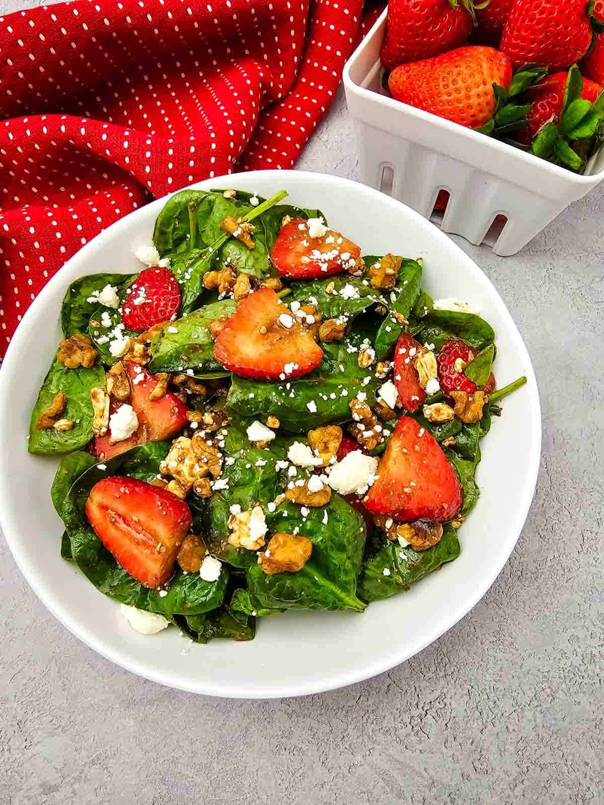 Looking for a fresh and easy salad recipe everyone will love? This Strawberry Spinach Salad is loaded with baby spinach, juicy fresh strawberries, crunchy walnuts, and creamy feta cheese, all tossed in a simple homemade balsamic dressing. It's the perfect healthy salad for spring and summer, whether you need a quick lunch, light dinner, side dish, picnic recipe, or potluck favorite. This easy spinach salad comes together in just 10 minutes with simple ingredients and is packed with sweet and savory flavor in every bite. Save this strawberry salad recipe for busy weeknights, holiday meals, BBQs, bridal showers, Mother's Day brunch, or anytime you're craving a fresh, colorful, and delicious salad that's both beautiful and satisfying.