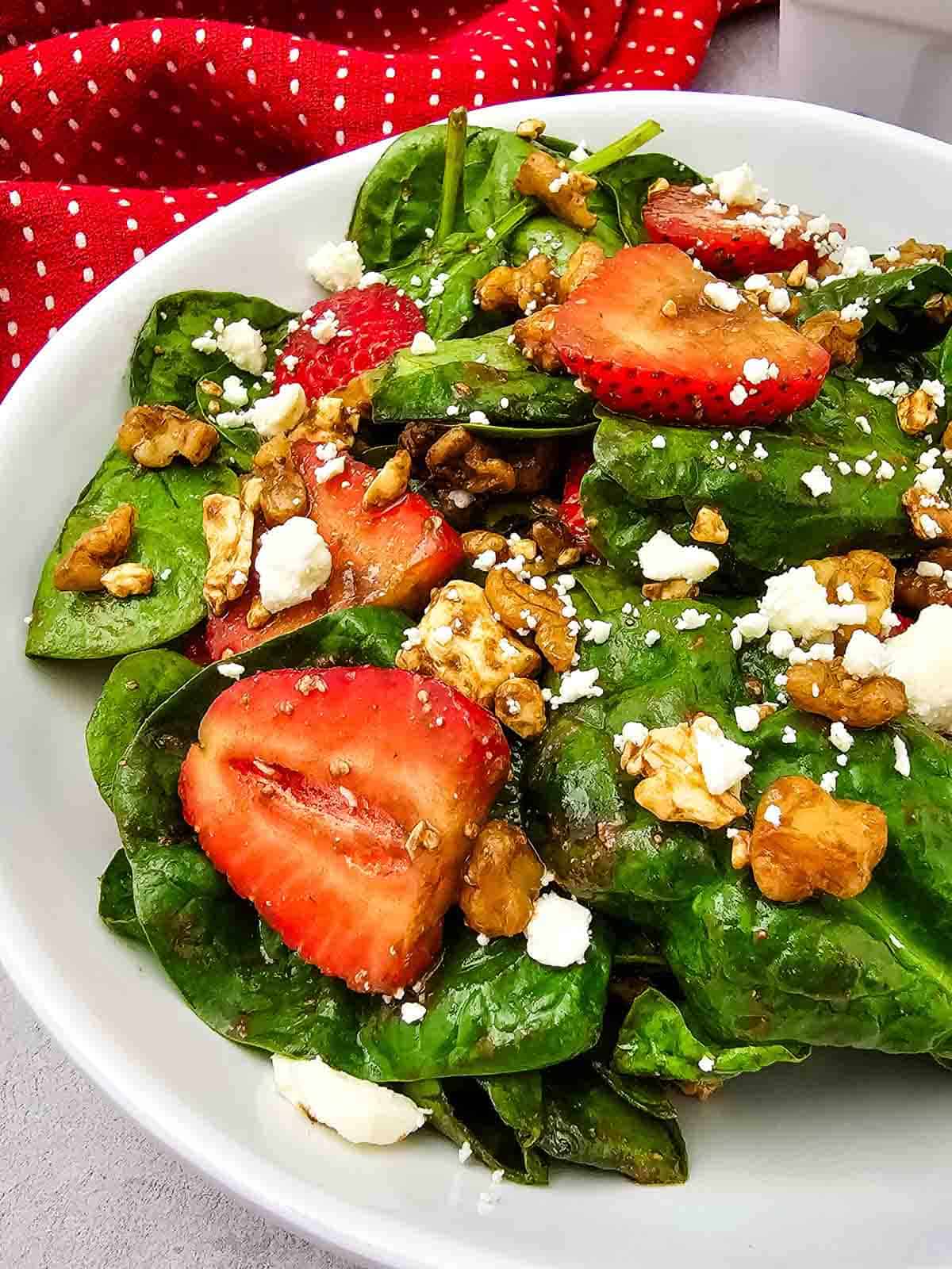 Looking for a fresh and easy salad recipe everyone will love? This Strawberry Spinach Salad is loaded with baby spinach, juicy fresh strawberries, crunchy walnuts, and creamy feta cheese, all tossed in a simple homemade balsamic dressing. It's the perfect healthy salad for spring and summer, whether you need a quick lunch, light dinner, side dish, picnic recipe, or potluck favorite. This easy spinach salad comes together in just 10 minutes with simple ingredients and is packed with sweet and savory flavor in every bite. Save this strawberry salad recipe for busy weeknights, holiday meals, BBQs, bridal showers, Mother's Day brunch, or anytime you're craving a fresh, colorful, and delicious salad that's both beautiful and satisfying.