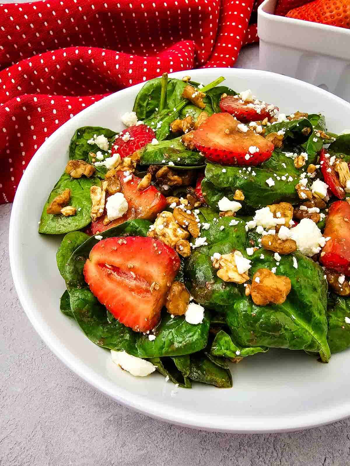 Looking for a fresh and easy salad recipe everyone will love? This Strawberry Spinach Salad is loaded with baby spinach, juicy fresh strawberries, crunchy walnuts, and creamy feta cheese, all tossed in a simple homemade balsamic dressing. It's the perfect healthy salad for spring and summer, whether you need a quick lunch, light dinner, side dish, picnic recipe, or potluck favorite. This easy spinach salad comes together in just 10 minutes with simple ingredients and is packed with sweet and savory flavor in every bite. Save this strawberry salad recipe for busy weeknights, holiday meals, BBQs, bridal showers, Mother's Day brunch, or anytime you're craving a fresh, colorful, and delicious salad that's both beautiful and satisfying.