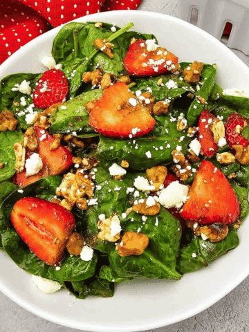 Looking for a fresh and easy salad recipe everyone will love? This Strawberry Spinach Salad is loaded with baby spinach, juicy fresh strawberries, crunchy walnuts, and creamy feta cheese, all tossed in a simple homemade balsamic dressing. It's the perfect healthy salad for spring and summer, whether you need a quick lunch, light dinner, side dish, picnic recipe, or potluck favorite. This easy spinach salad comes together in just 10 minutes with simple ingredients and is packed with sweet and savory flavor in every bite. Save this strawberry salad recipe for busy weeknights, holiday meals, BBQs, bridal showers, Mother's Day brunch, or anytime you're craving a fresh, colorful, and delicious salad that's both beautiful and satisfying.