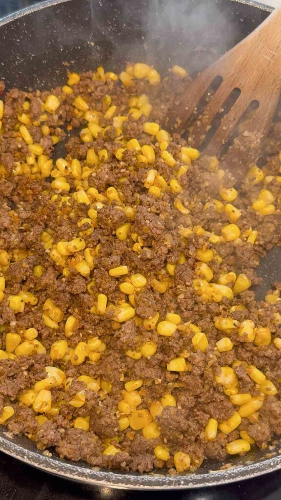 cooked ground beef adn corn mixture in a skillet