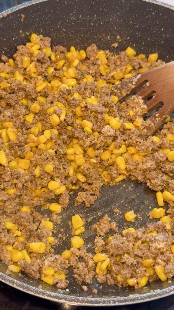 sour cream stirred into ground beef and corn mixture in a skillet