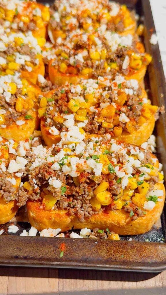 Need an easy dinner that's guaranteed to disappear fast? These Street Corn Beef Garlic Toasts combine crispy Texas garlic toast with seasoned ground beef, smoky street corn, melty mozzarella, tangy Cotija cheese, and a creamy lime sauce for the ultimate family meal. This easy ground beef recipe is perfect for busy weeknights, game day appetizers, party snacks, or quick comfort food dinners. If you're searching for easy dinner recipes, garlic bread recipes, ground beef dinner ideas, Texas toast recipes, Mexican-inspired recipes, street corn recipes, cheesy beef recipes, easy appetizer ideas, or family-friendly meals, this delicious recipe is packed with bold flavor, simple ingredients, and is ready in just 35 minutes. Save this recipe for your next easy weeknight dinner!