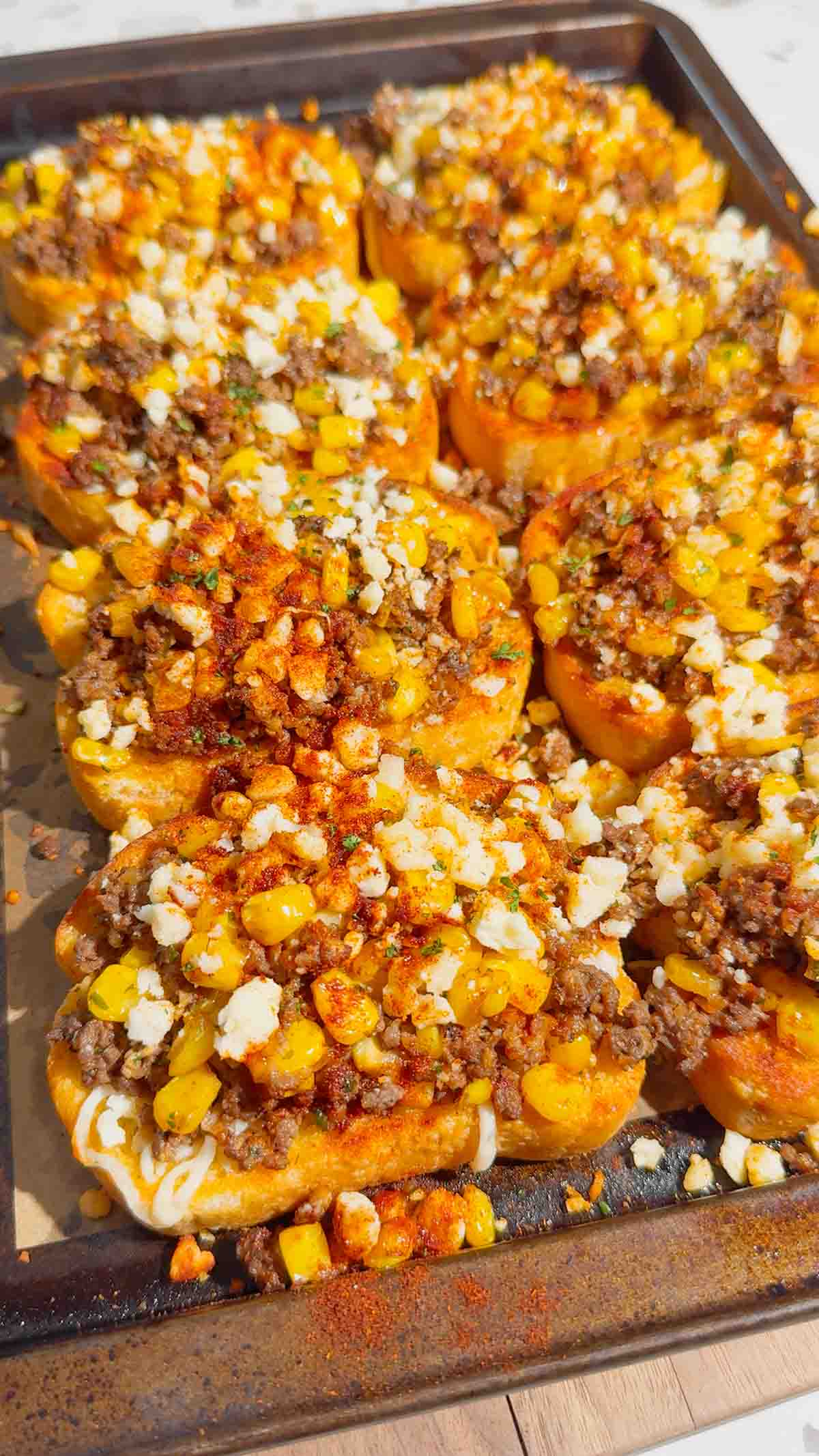 Need an easy dinner that's guaranteed to disappear fast? These Street Corn Beef Garlic Toasts combine crispy Texas garlic toast with seasoned ground beef, smoky street corn, melty mozzarella, tangy Cotija cheese, and a creamy lime sauce for the ultimate family meal. This easy ground beef recipe is perfect for busy weeknights, game day appetizers, party snacks, or quick comfort food dinners. If you're searching for easy dinner recipes, garlic bread recipes, ground beef dinner ideas, Texas toast recipes, Mexican-inspired recipes, street corn recipes, cheesy beef recipes, easy appetizer ideas, or family-friendly meals, this delicious recipe is packed with bold flavor, simple ingredients, and is ready in just 35 minutes. Save this recipe for your next easy weeknight dinner!