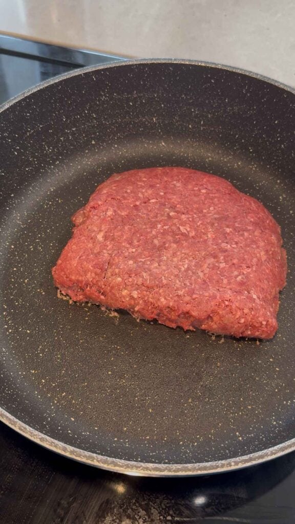 raw ground beef in a skillet