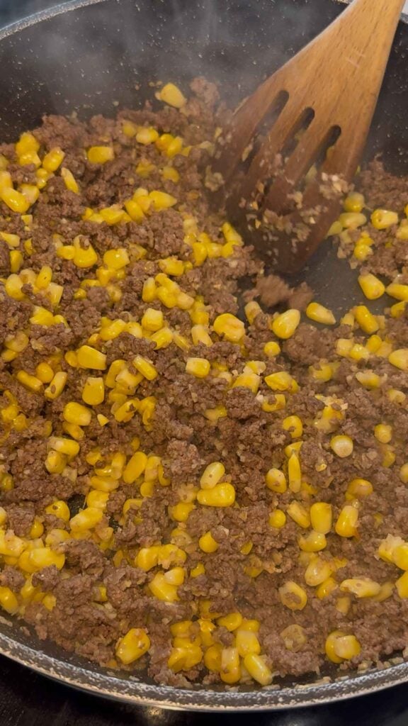 cooked ground beef, corn and dehyrdrated onion mixture in a skillet