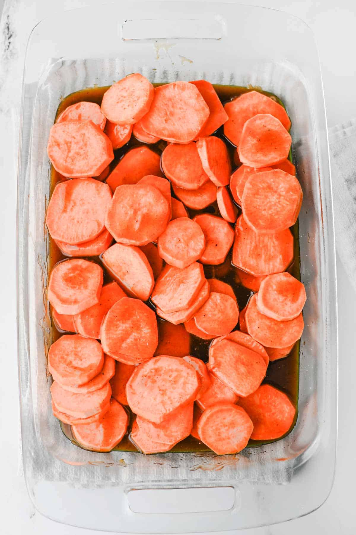 sliced sweet potatoes in a baking dish
