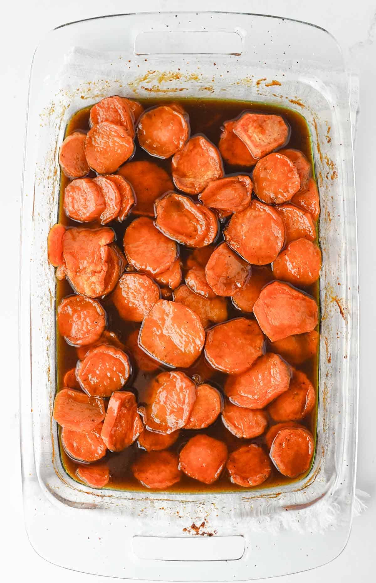 These Candied Sweet Potatoes are the ultimate sweet and buttery side dish for Thanksgiving, Christmas, Sunday dinner, and cozy fall meals! Tender sliced sweet potatoes are baked in a rich brown sugar and maple syrup glaze with butter, cinnamon, nutmeg, ginger, and vanilla for incredible caramelized flavor in every bite. If you’re searching for an Easy Candied Sweet Potatoes Recipe, Southern Candied Sweet Potatoes, Baked Sweet Potato Recipes, Thanksgiving Sweet Potato Recipes, Holiday Side Dishes, or Easy Thanksgiving Sides, save this one! These Maple Candied Sweet Potatoes require simple ingredients and just 20 minutes of prep. Serve these glazed sweet potatoes alongside turkey, ham, chicken, or roast beef for a comforting side dish everyone will be excited to see on the dinner table.