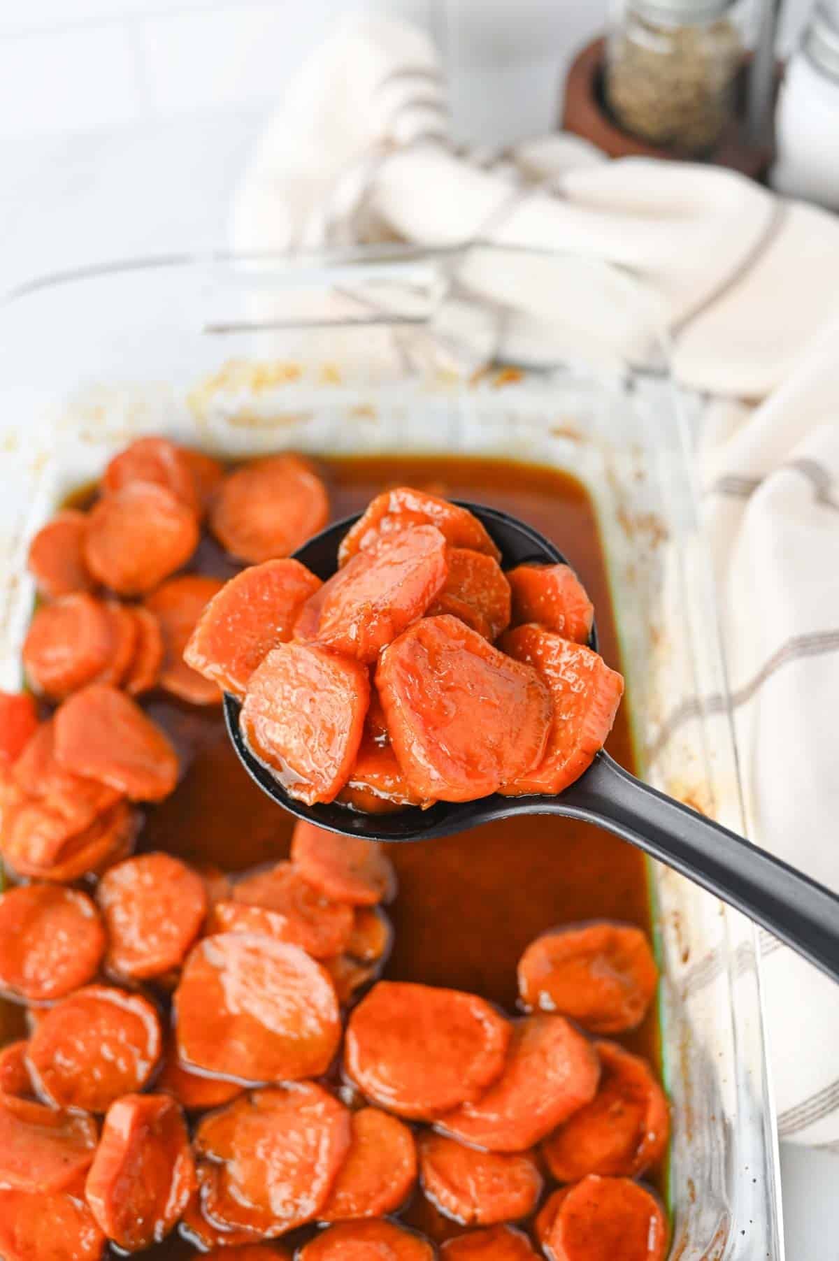 These Candied Sweet Potatoes are the ultimate sweet and buttery side dish for Thanksgiving, Christmas, Sunday dinner, and cozy fall meals! Tender sliced sweet potatoes are baked in a rich brown sugar and maple syrup glaze with butter, cinnamon, nutmeg, ginger, and vanilla for incredible caramelized flavor in every bite. If you’re searching for an Easy Candied Sweet Potatoes Recipe, Southern Candied Sweet Potatoes, Baked Sweet Potato Recipes, Thanksgiving Sweet Potato Recipes, Holiday Side Dishes, or Easy Thanksgiving Sides, save this one! These Maple Candied Sweet Potatoes require simple ingredients and just 20 minutes of prep. Serve these glazed sweet potatoes alongside turkey, ham, chicken, or roast beef for a comforting side dish everyone will be excited to see on the dinner table.