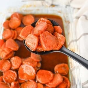 These Candied Sweet Potatoes are the ultimate sweet and buttery side dish for Thanksgiving, Christmas, Sunday dinner, and cozy fall meals! Tender sliced sweet potatoes are baked in a rich brown sugar and maple syrup glaze with butter, cinnamon, nutmeg, ginger, and vanilla for incredible caramelized flavor in every bite. If you’re searching for an Easy Candied Sweet Potatoes Recipe, Southern Candied Sweet Potatoes, Baked Sweet Potato Recipes, Thanksgiving Sweet Potato Recipes, Holiday Side Dishes, or Easy Thanksgiving Sides, save this one! These Maple Candied Sweet Potatoes require simple ingredients and just 20 minutes of prep. Serve these glazed sweet potatoes alongside turkey, ham, chicken, or roast beef for a comforting side dish everyone will be excited to see on the dinner table.
