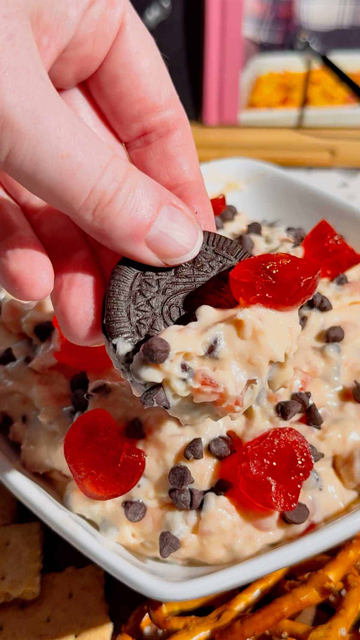 Cherry Chocolate Chip Dip is an easy no bake dessert dip loaded with creamy cream cheese, sweet cherries and mini chocolate chips. This quick dessert dip takes just 15 minutes to make and is perfect for parties, holidays, potlucks, Valentine's Day treats and easy entertaining. If you love chocolate chip dip, cherry desserts, cheesecake dip and sweet cream cheese dip recipes, this simple party dessert is a must-try. Serve this cherry chocolate chip cheesecake dip with graham crackers, vanilla wafers, pretzels, cookies or fresh fruit for dipping. Made with cream cheese, butter, brown sugar, vanilla, candied cherries and chocolate chips, it's a rich and creamy no bake treat. Save this easy dessert dip recipe for your next party, holiday dessert table, girls' night or last-minute sweet treat!